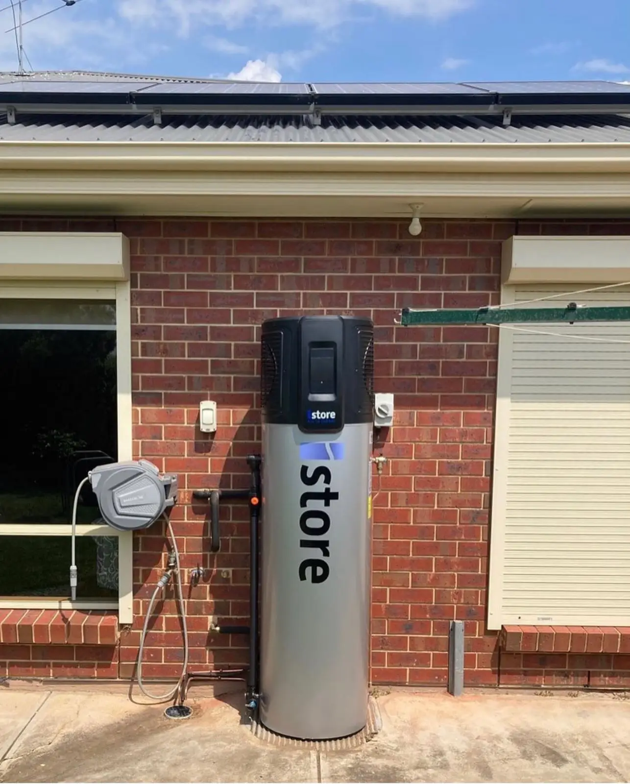 Heat pump installation on brick wall